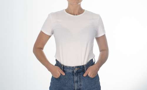 Torso Of A Person Standing In White Shirt And Blue Jeans Photo