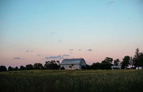 Large Blue Barn In The Countryside At Sunset Photo