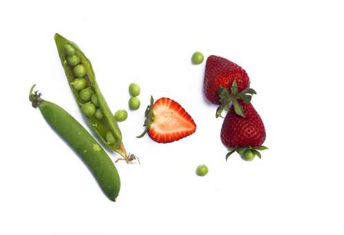 Scattered Green Peas In Their Pod With Strawberries Photo