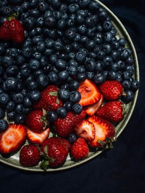 Summer Strawberries And Blueberries On Blue Linen Cloth Photo