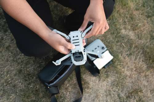 Person Holds A Drone Outdoors And Gets It Ready To Fly Photo