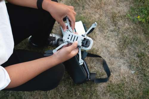 Person Gets A Drone Ready For Flight Outdoors Photo