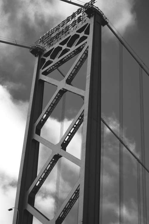 The Ambassador Bridge Viewed Below In Black And White Photo