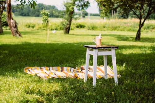 Cup of coffee on a vintage stool outdoors