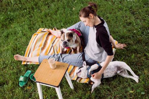Female having a coffee outdoors with dogs 3