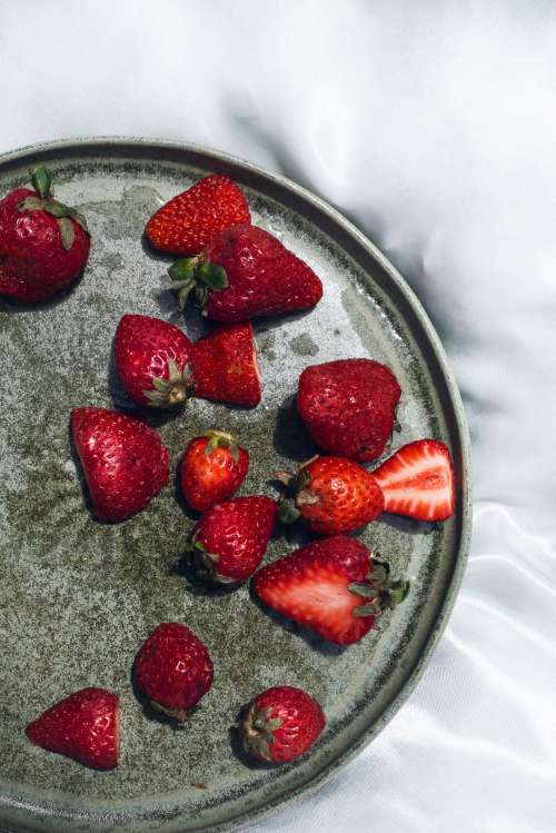 Flatlay Of Ripe Strawberries On A Green Plate On Silk Photo