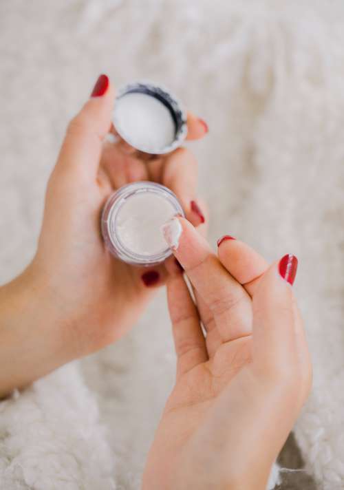 Hands Hold A Small Cosmetics Container Photo