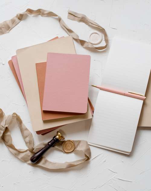 Flatlay Of Notebooks A Ribbon And A Wax Seal Photo