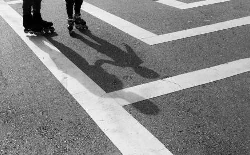 Black And White Photo Of Peoples Feet Wearing Rollerblades Photo