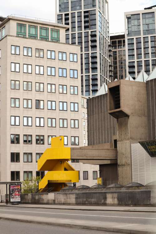 Photo Of City Buildings And A Yellow Staircase Photo