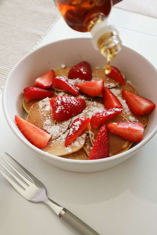 White Bowl With Mini Pancakes With Cut Strawberries Photo