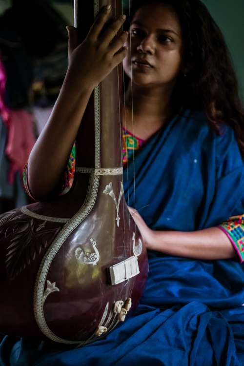 Woman Holds A Large Musical Instrument Photo