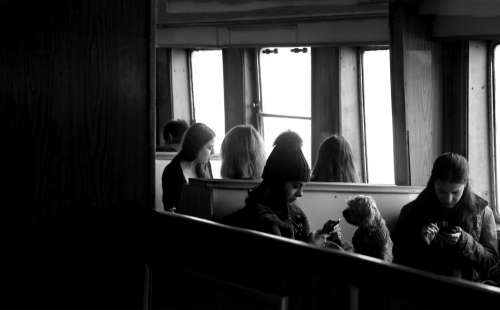 People Sitting By A Window In Conversation Photo