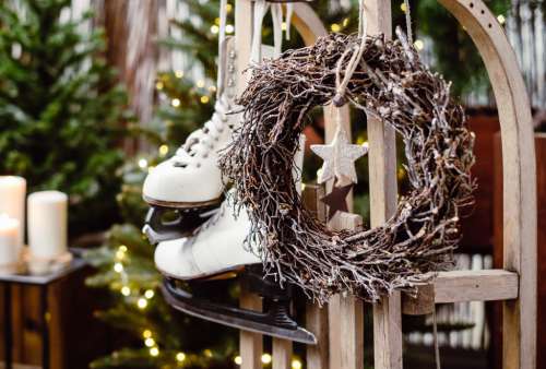 Christmas wreath and vintage ice skates on a wooden sled