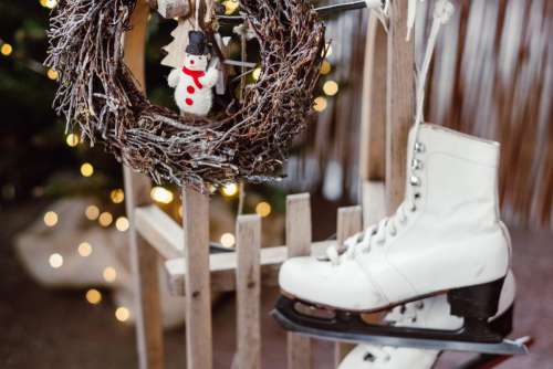 Christmas wreath and vintage ice skates on a wooden sled 2
