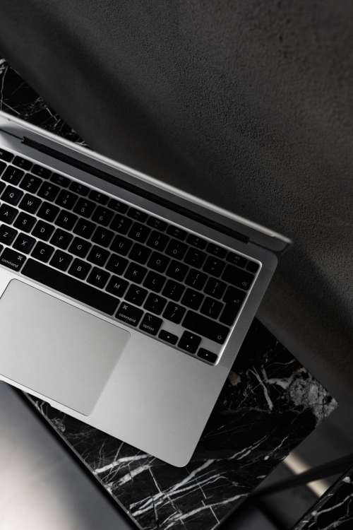 Macbook Pro laptop - marble - decorative plaster on wall - black aesthetics