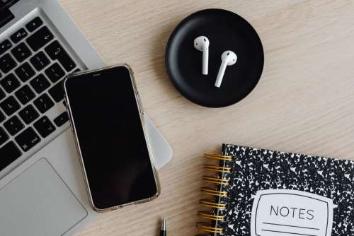 Workspace - laptop - AirPods - desk - notebooks - mobile phone