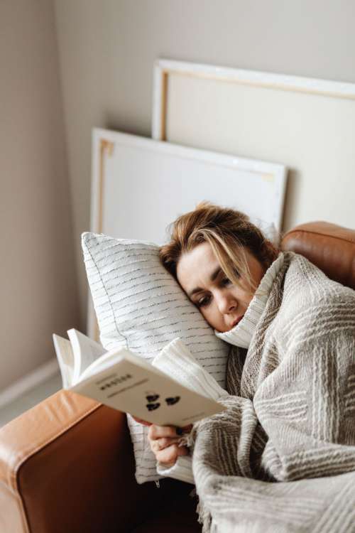 Cocooning - isolating yourself - stay at home - woman under blanket