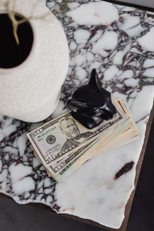 Dollar bills on a marble table