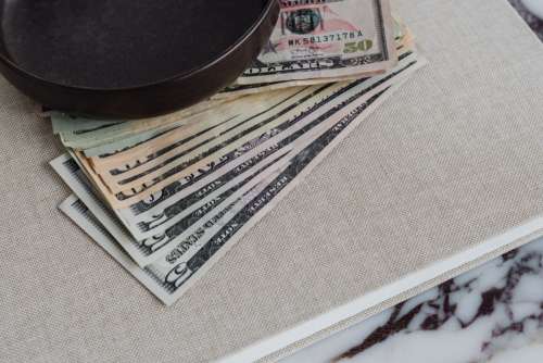 Dollar bills on a marble table