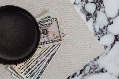 Dollar bills on a marble table