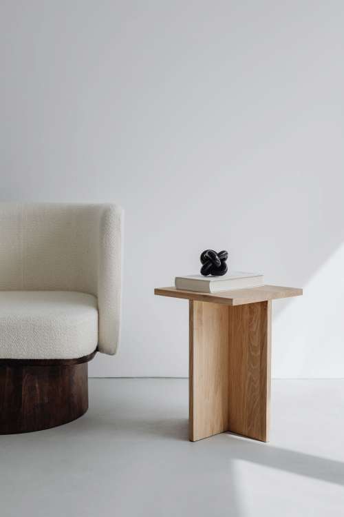 Modern oak side table - armchair with light boucle fabric - minimalist interior