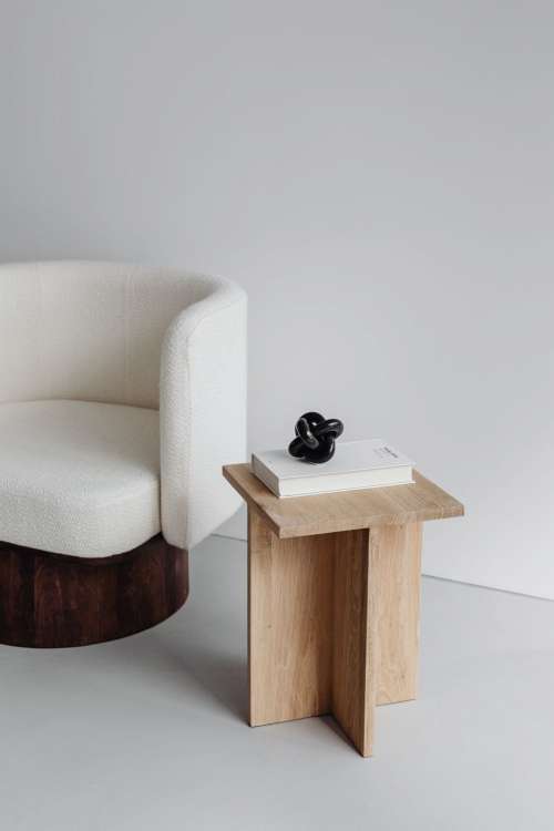 Modern oak side table - armchair with light boucle fabric - minimalist interior