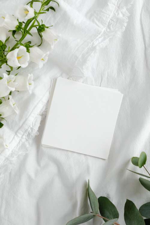 Mockup photo - white bedding - flowers - blank sheet - square