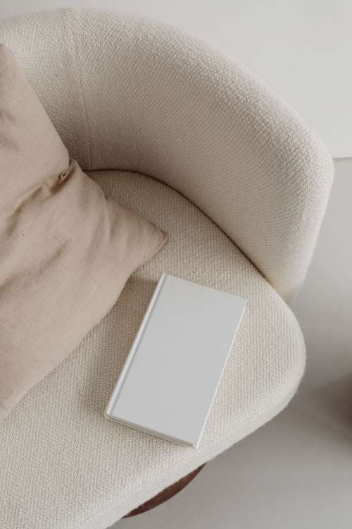 Free photos for mockups - blank cover book - cream armchair - linen pillow