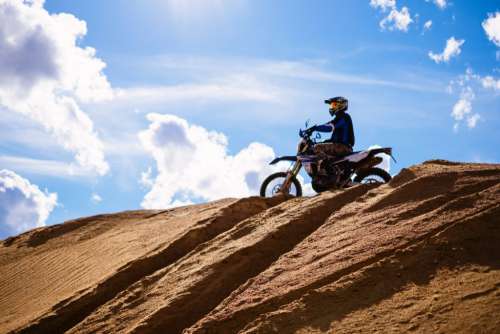 Motor biker on a hill at a sand quarry 2