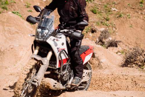Motor biker riding through a sand quarry 3