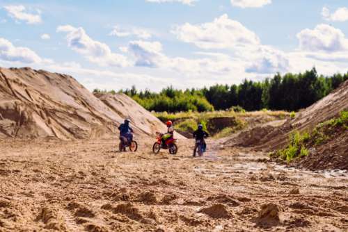 Three bikers at a sand quarry