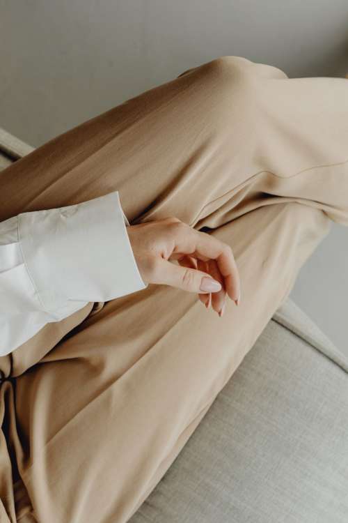 Minimal fashion - Unrecognizable Woman in beige trousers