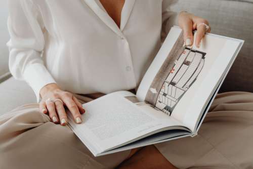 Elegantly dressed female architect with a book