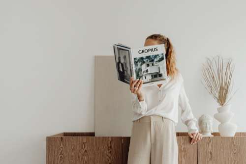 Elegantly dressed female architect with a book