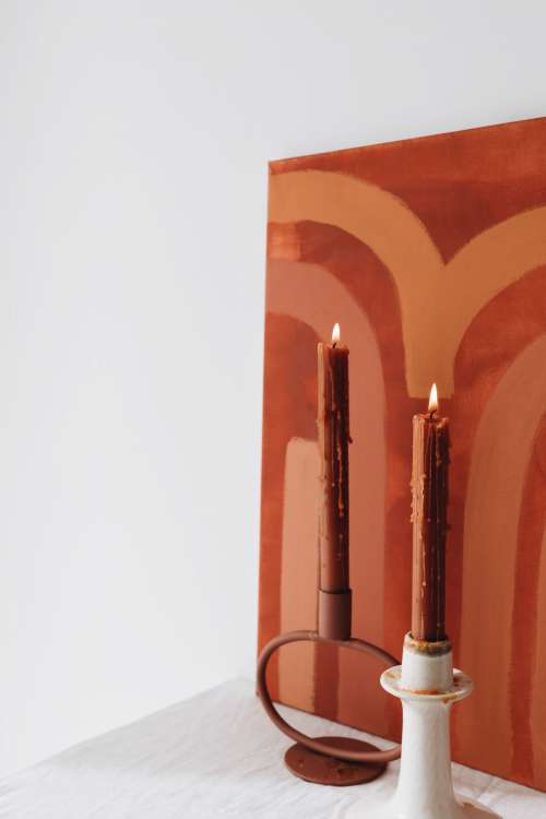 Orange-colored candles on the background of the painting