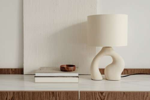 Ceramic lamp styled on a commode with a stone top