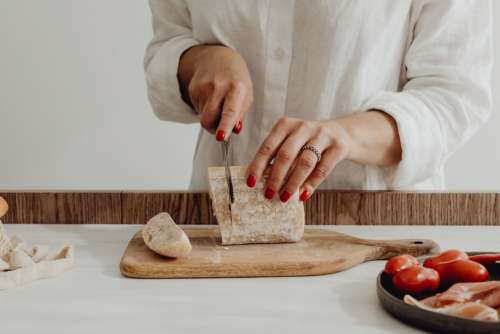 Woman making bruschetta with healthy ingredients
