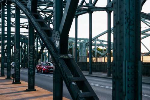 Modern cars driving across an industrial overpass