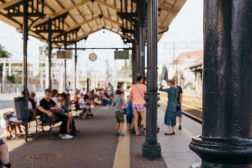 People waiting for a train at a railway station