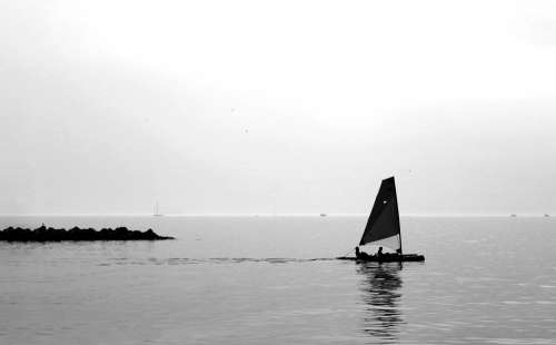 Black And White Photo Of A Sail Boat On Still Water Photo