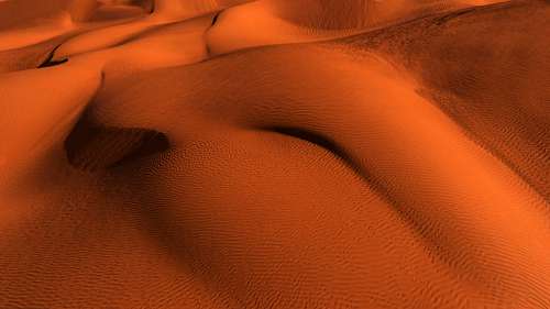 Hills Of Vibrant Orange Sand And Wavy Texture Photo