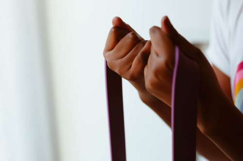 Hands Tightly Grip A Purple Rope Photo