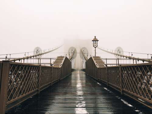 A Wet Bridge Covered In Fog Photo
