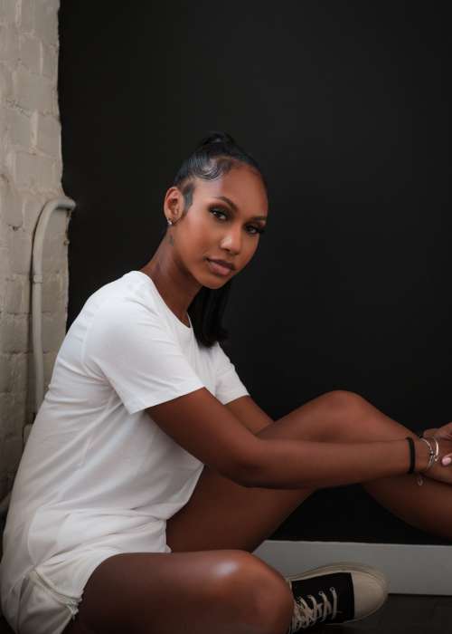 Woman Dressed In All White Sits On The Ground Photo