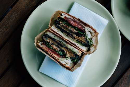 Half Sandwich In Brown Paper Freshly Sliced Photo