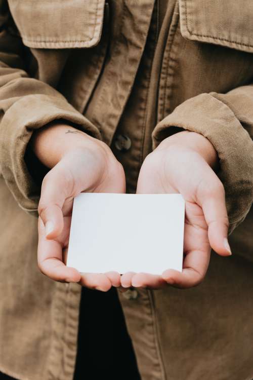 Person Cups A Blank Piece Of White Paper In Hands Photo