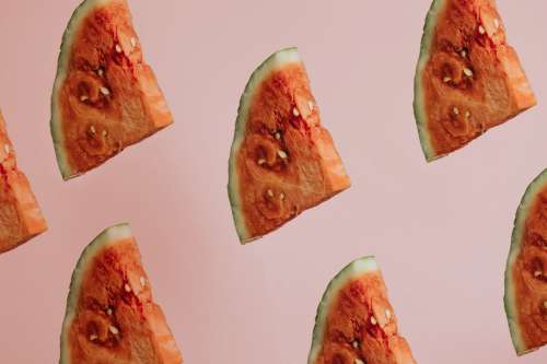 Triangle Slices Of Watermelon On Pink Background Photo