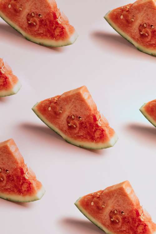 Bright Red Watermelon Slices On Pink Background Photo