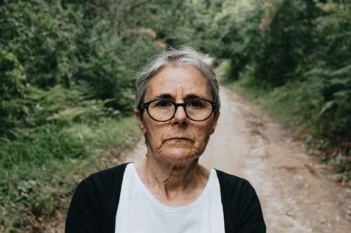 Woman In Glasses Looks At The Camera With A Trail Behind Her Photo